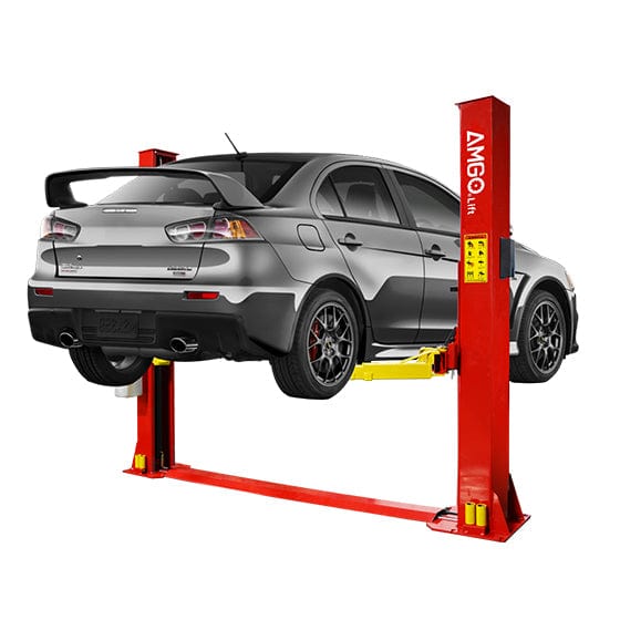 A grey car is lifted on an AMGO BP-9 9,000 lbs 2 Post Lift from AMGO Hydraulics, featuring a red base-plate in a low-ceiling garage, showcasing its undercarriage.