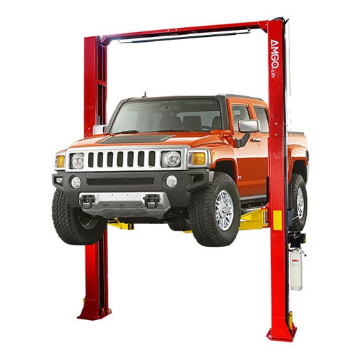 An orange Hummer is lifted on a red AMGO OH-15 15,000 lbs 2 Post Lift by AMGO Hydraulics in an auto repair shop, showcasing its heavy lifting capabilities.