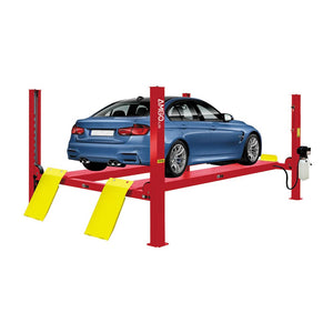 A blue car on an AMGO Hydraulics AMGO PRO-12SX 12,000 lbs 4 Post Lift, a red four-post lift with yellow ramps, set in a workshop environment. Ideal for handling vehicles up to 12,000 lbs capacity.