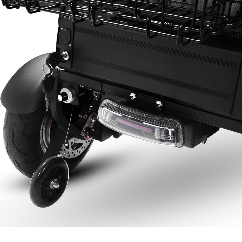 Close-up of the rear wheel and brake light of the MotoTec Folding Mobility Electric Trike 48v 1000w Dual Motor Lithium Black, featuring a small side stabilizer wheel.