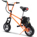 The MotoTec 49cc Gas Mini Bike V2, by MotoTec, features an orange frame with small tires, a padded black seat, BMX-style handlebars, and a 49cc gas engine mounted on the back wheel.