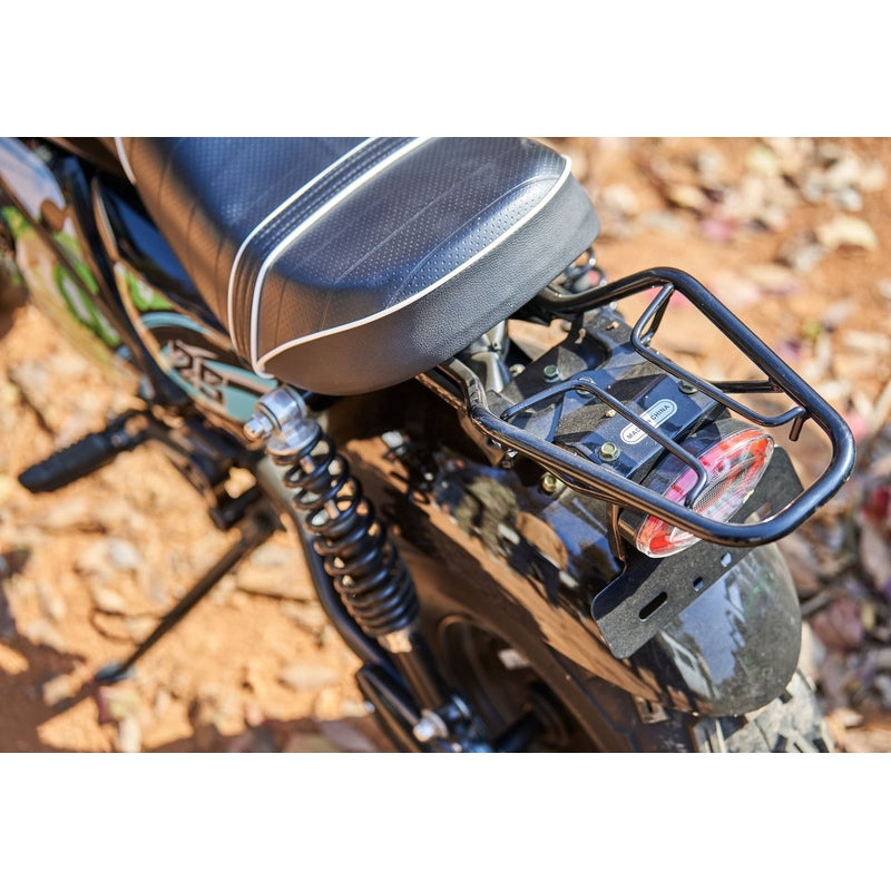 Close-up of the rear section of a MotoTec 60v 1500w Electric Powered Mini Bike Lithium Black, showcasing the seat, rear rack, suspension, and taillight on a dirt ground.