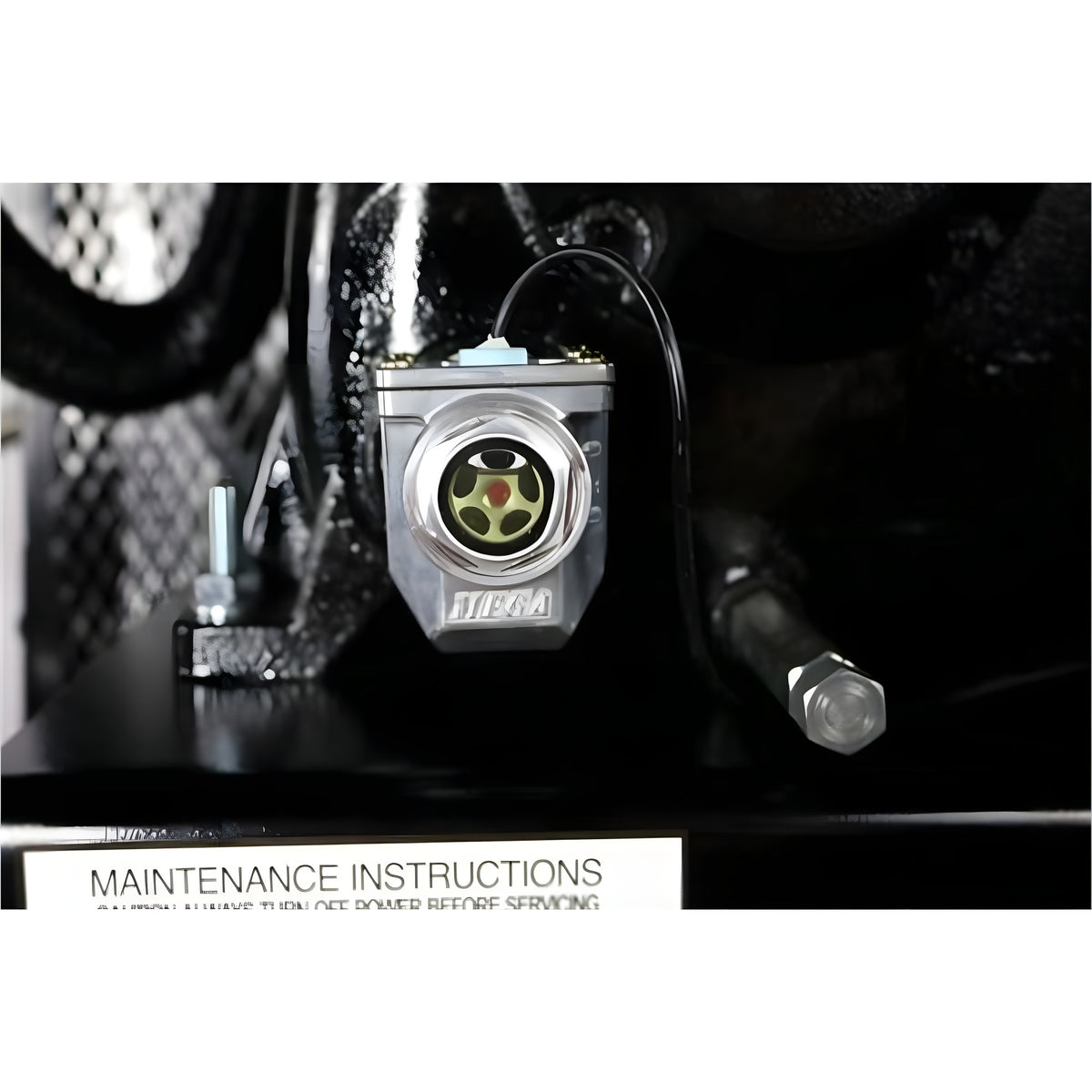 Chrome oil-level sight glass with low-oil shut-off sensor and wiring, mounted above the maintenance-instructions label