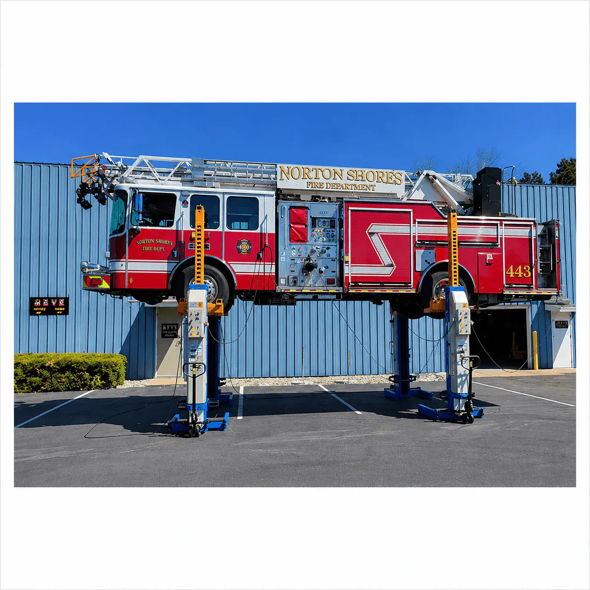 Atlas ML-4034BC mobile column lift system raising a Norton Shores Fire Department fire truck outdoors