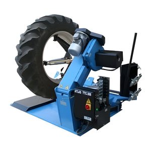 Atlas TTC306 tire changer tilted table holding large tractor tire
