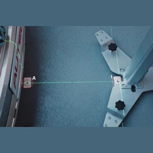 Close-up of green laser positioning lines projecting onto a calibration mat from the MA600 base