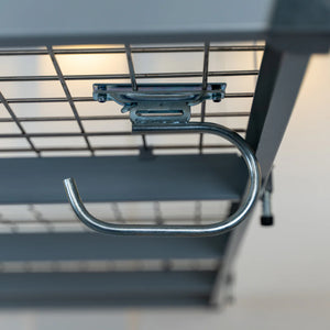 Bright zinc-finished metal storage hook clamped to the underside wire mesh of an overhead garage rack