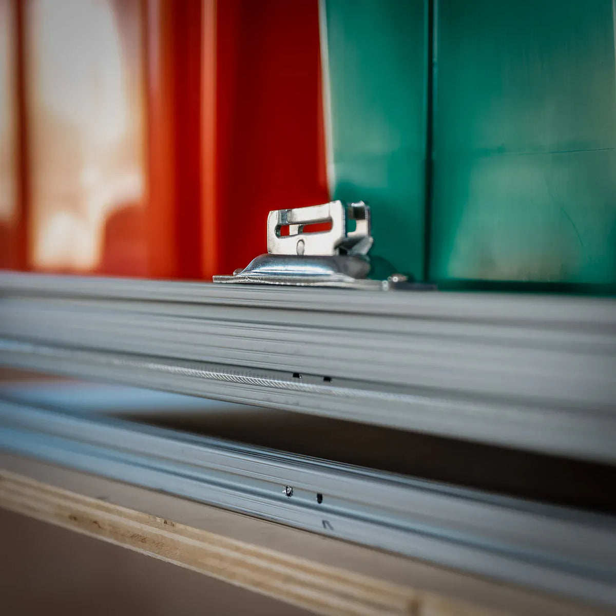 Close-up of the platform's aluminum T-slot frame rail and a metal mounting fitting