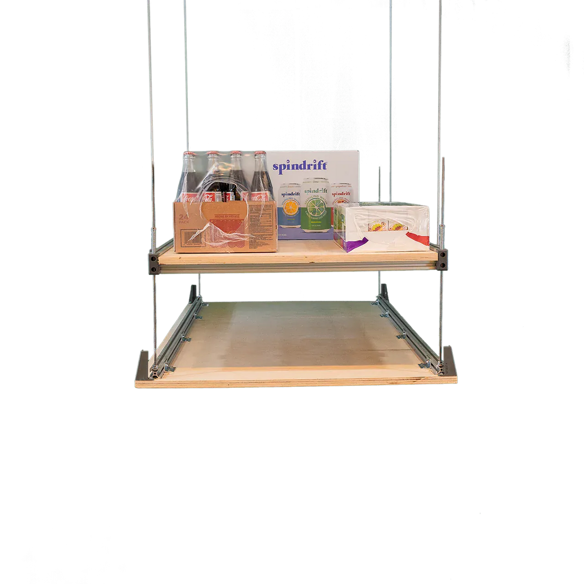 Attic-Lift platform deck loaded with boxed beverages and household goods, studio shot