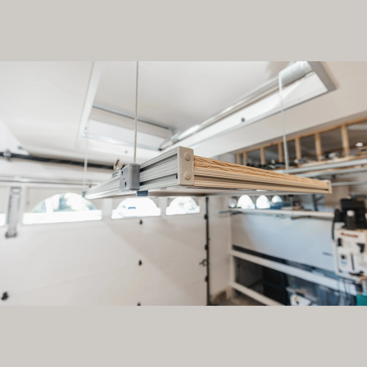 Empty Attic-Lift platform suspended near a garage ceiling, side view