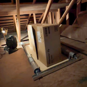 Attic-Lift delivering an equipment box up into an attic among the roof framing
