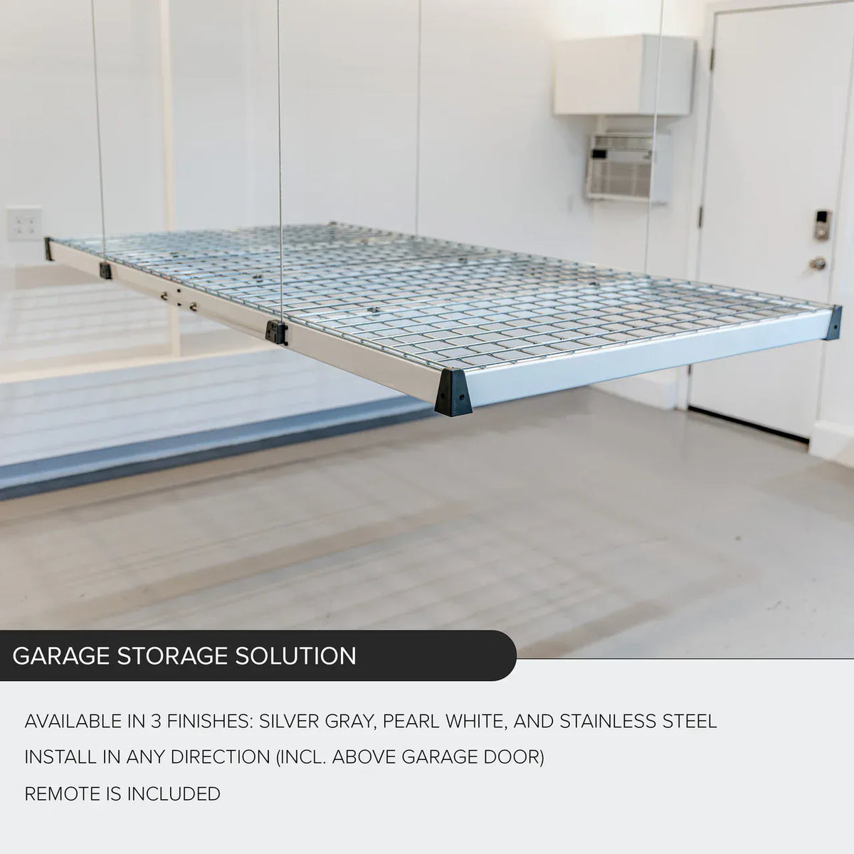 Side view of an empty Auxx-Lift wire-mesh storage platform suspended on cables in a white garage