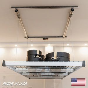 Auxx-Lift platform holding two round cases, with a Made in USA flag graphic