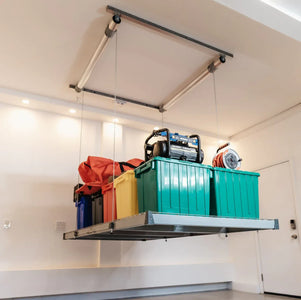 Auxx-Lift platform mounted in a garage corner holding drum shells and storage boxes