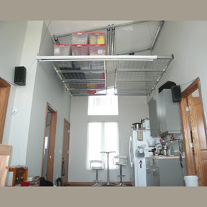 Auxx-Lift platform mounted high in a loft, holding clear storage totes with red lids