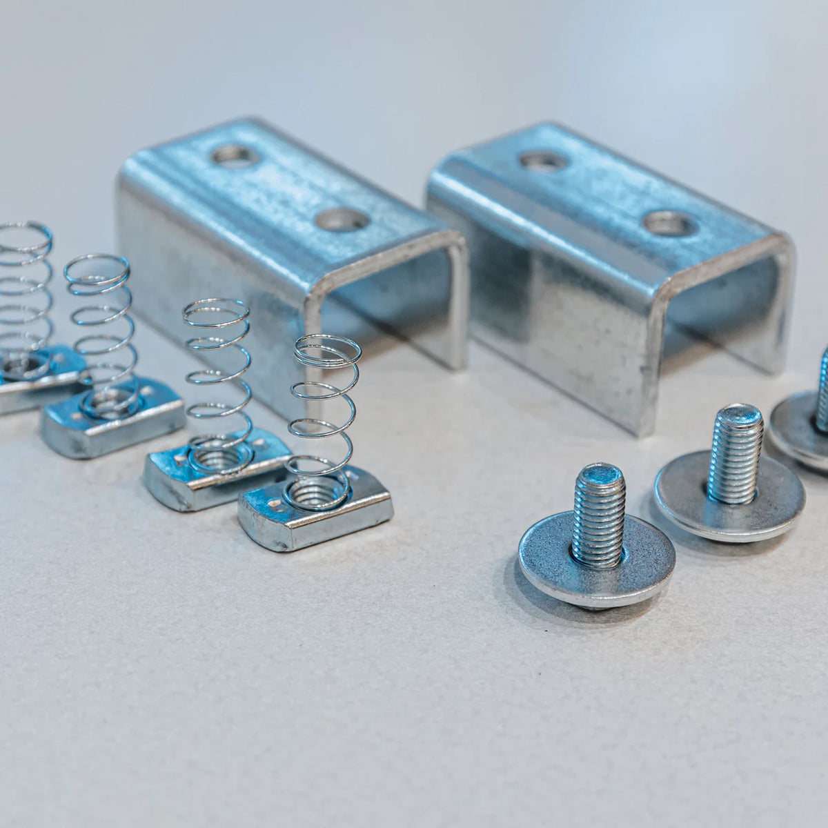 Zinc U-channel brackets, spring channel nuts, and flanged bolts