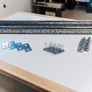 Auxx-Lift hardware kit components: galvanized rails, mounting plates, spring channel nuts, and bolts