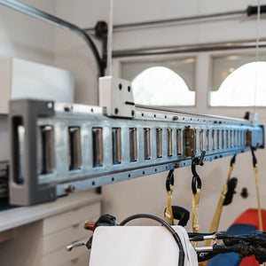 Close-up of the galvanized E-Beam track, carriage, and hanging strap hooks