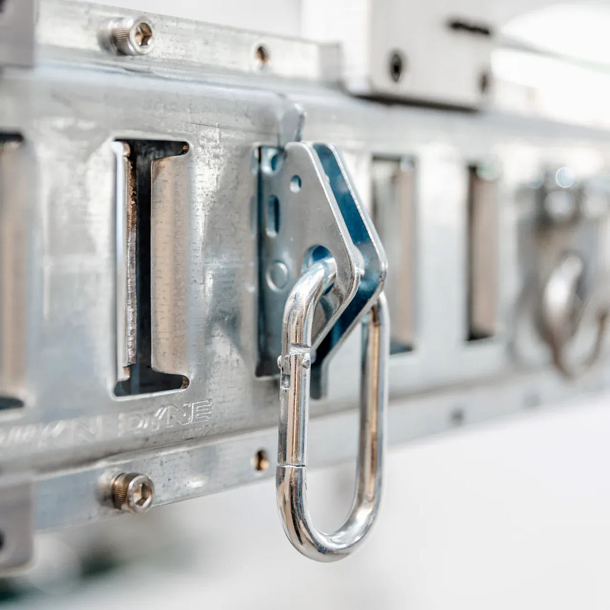 Carabiner snap-in anchor clipped into the galvanized E-Beam track