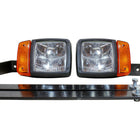 Two halogen snowplow lights with amber turn signals on black mounting brackets with bolts
