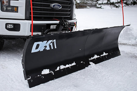 DK2 snow plow with electric winch mounted on a white Ford pickup in snow