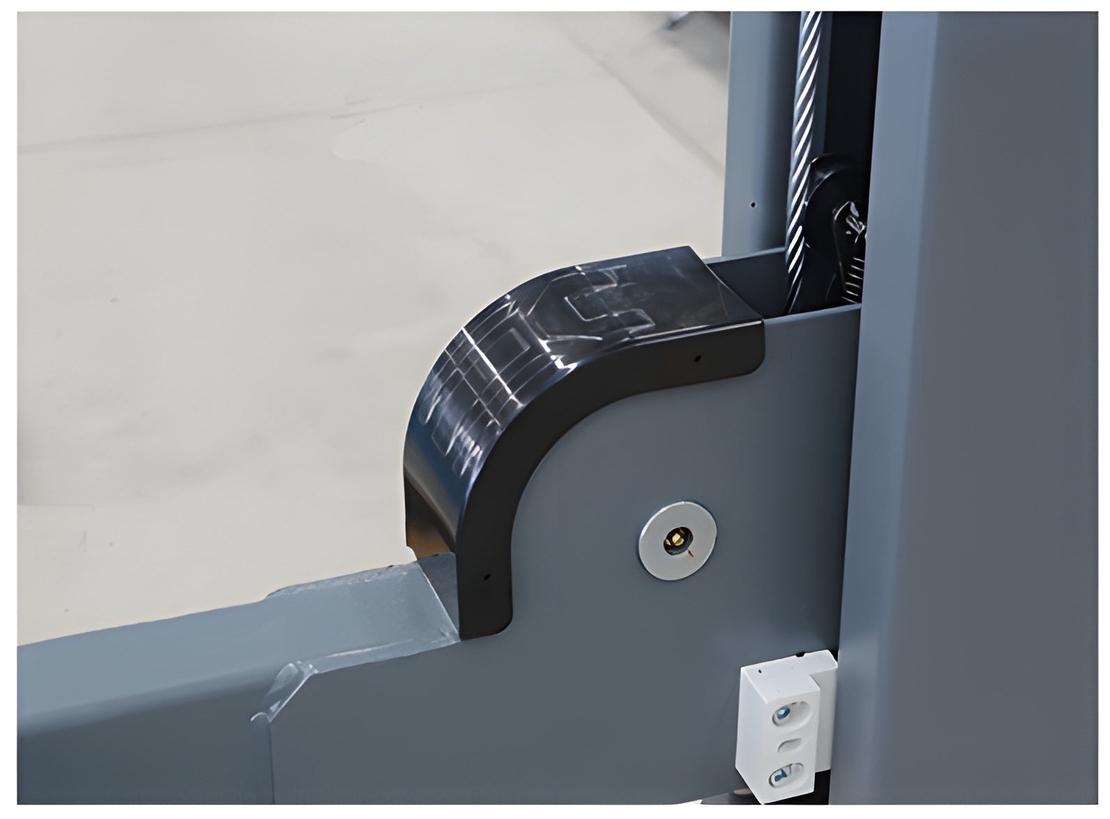 Black cable cover at the runway-to-post junction
