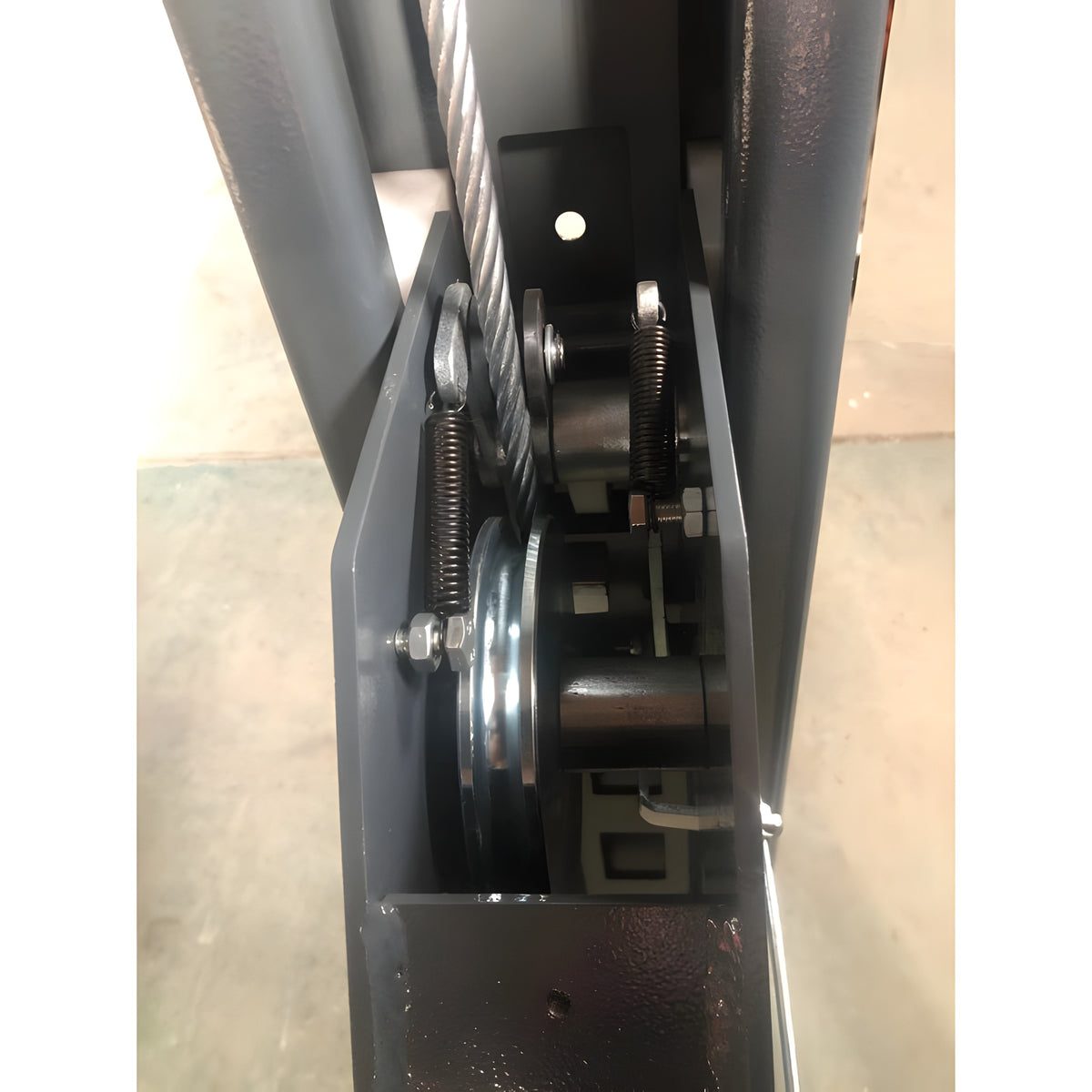 Cable sheave and safety lock close-up inside the column