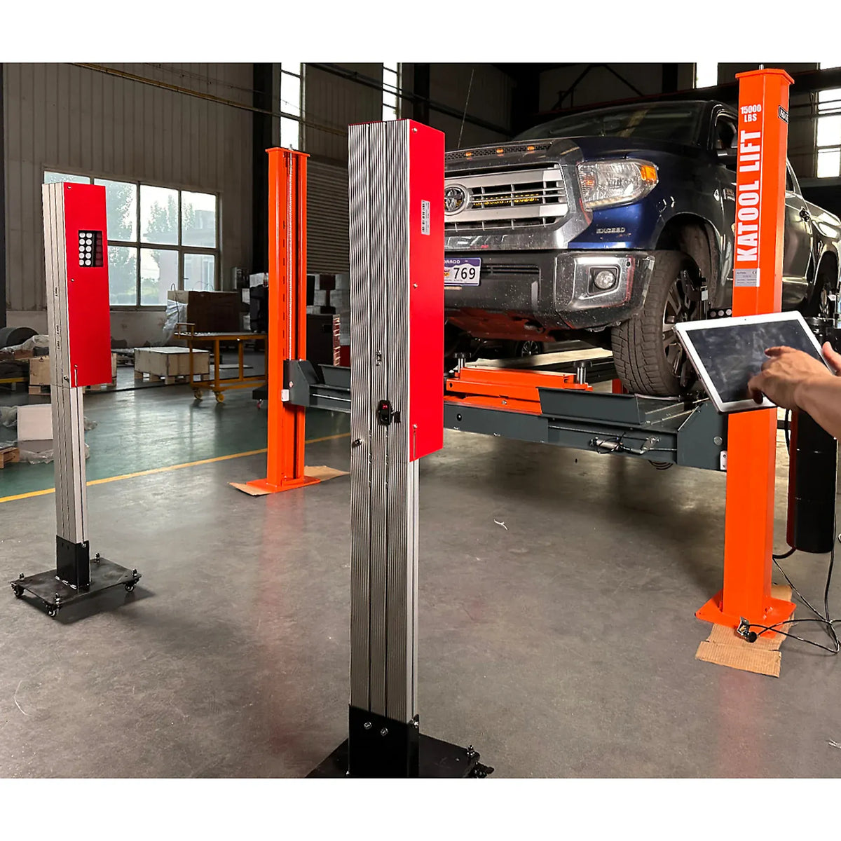 Katool KT-5DA installed in a working shop alongside a two-post lift and Toyota Tundra