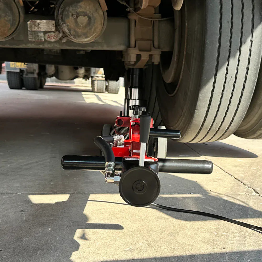 Katool KT-J80T positioned beneath a truck rear axle showing low under-vehicle clearance
