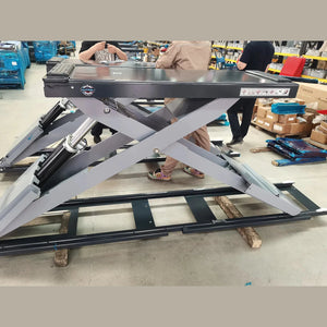 Katool KT-X99 full-rise scissor lift raised at full height for technician scale reference