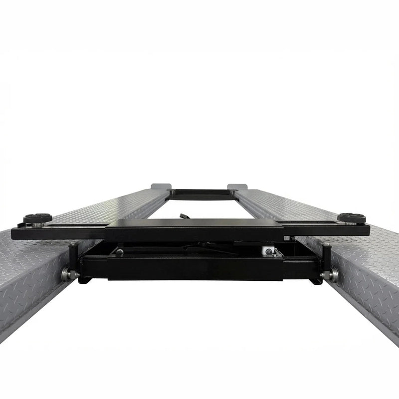 Top-down view of the rolling bridge jack spanning the four-post lift runways