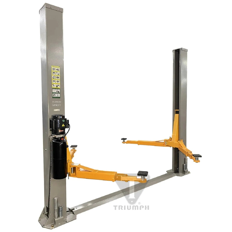Triumph NT-11 two-post lift, angled view of both columns, floor base plate, swing arms, and column-mounted hydraulic power unit