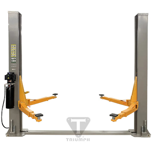 Triumph NT-11 two-post lift front view: grey columns on a floor base plate, orange swing arms, "11,000 LBS CAPACITY" marked on the column
