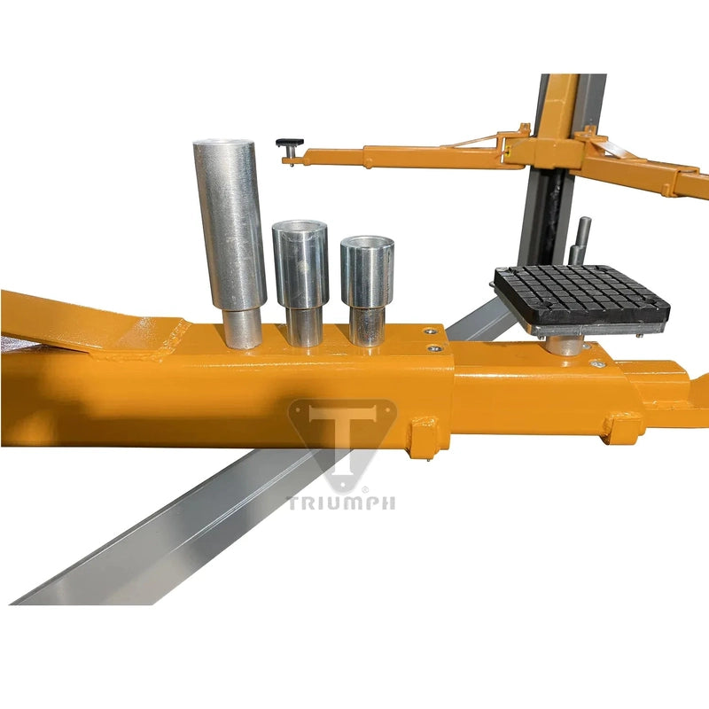 Three stacking steel truck adapters of different heights resting on an NT-11 lift arm beside a rubber pad