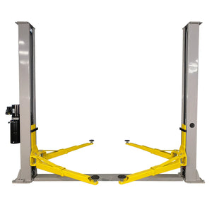 Triumph NT-9 two-post lift front view: two gray columns, floor-plate base, four yellow arms, column-mounted power unit