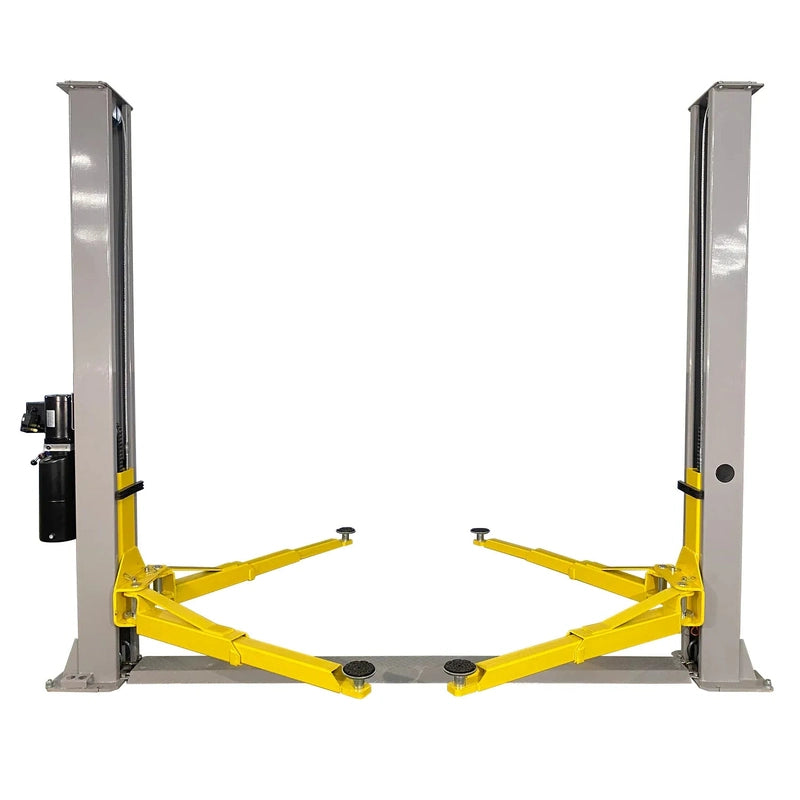 Triumph NT-9 two-post lift front view: two gray columns, floor-plate base, four yellow arms, column-mounted power unit
