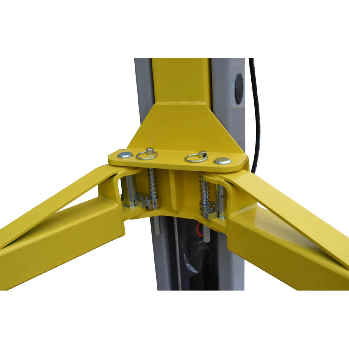 Close-up of the dual gear-type arm restraints with spring-loaded pull pins at the lift carriage