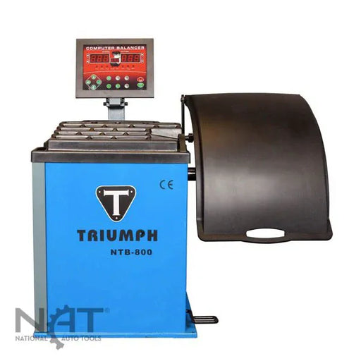 Triumph NTB-800 wheel balancer with computer display console, weight tray, and wheel hood guard