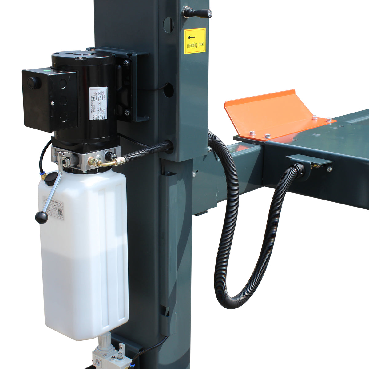Power unit on a lift post with black motor, white oil reservoir, release lever and unlocking reset label