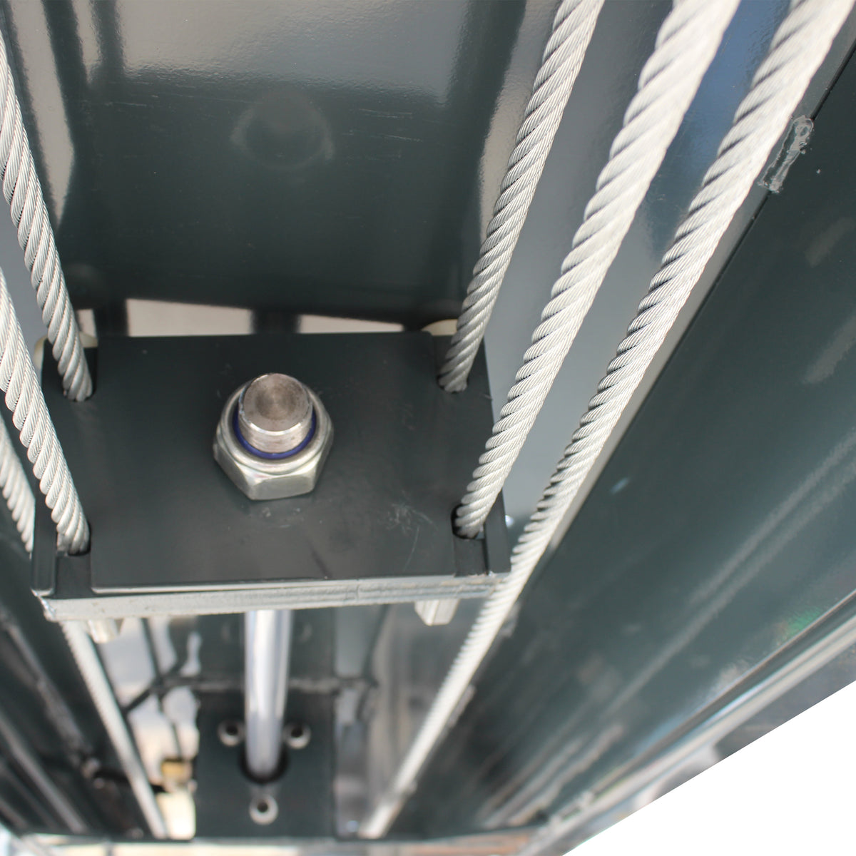 Underside view of the lift frame with steel lifting cables and a center mounting plate