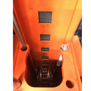 Inside the carriage: the column's multi-position safety-lock slots and cable sheave