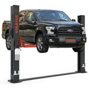 Stratus SAE-F12X two-post floor plate lift raising a black Ford F-150 pickup