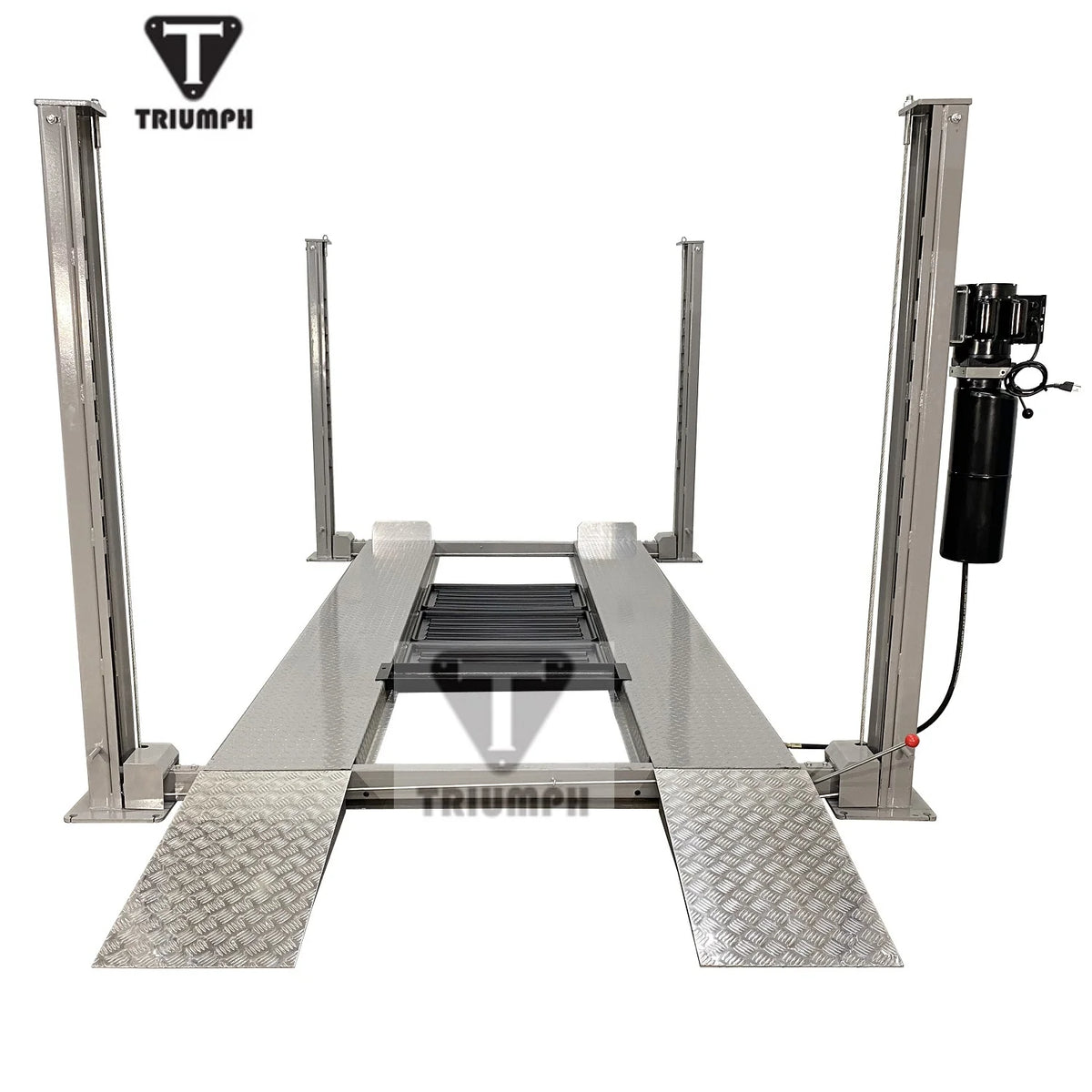 Front view of the four-post lift with diamond-plate drive-on approach ramps and center jack tray