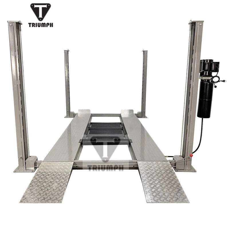 Front view of the four-post lift with diamond-plate drive-on approach ramps and center jack tray