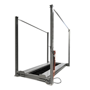 Lift fully lowered with both runways at floor level, coiled air hose on column