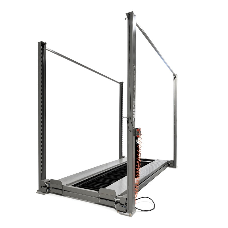 Lift fully lowered with both runways at floor level, coiled air hose on column