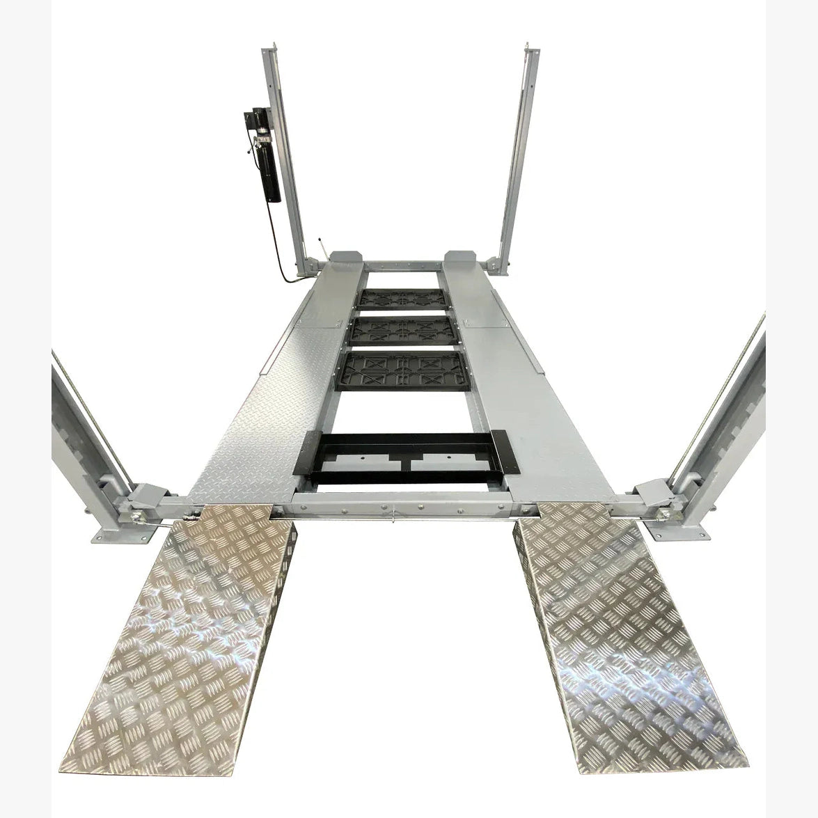 Drive-on view of Triumph NSS-8 X1 four-post lift with aluminum-look approach ramps and central drip trays