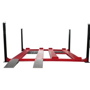 Triumph NSS9000 four-post lift deck lowered, two side-by-side runway lanes, drive-on ramps and side-mounted power unit