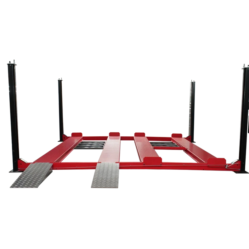 Triumph NSS9000 four-post lift deck lowered, two side-by-side runway lanes, drive-on ramps and side-mounted power unit