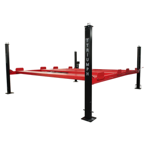 Triumph NSS9000 double-wide four-post storage lift, lowered, branded black columns and red diamond-plate runways